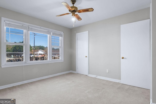 unfurnished bedroom with a ceiling fan, baseboards, and carpet floors