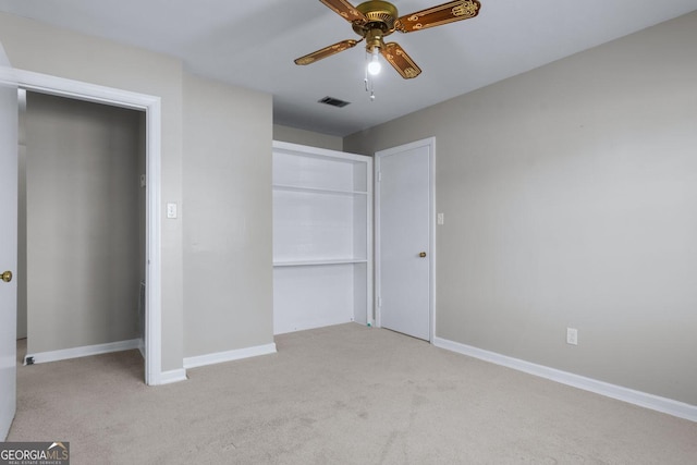 unfurnished bedroom featuring visible vents, baseboards, carpet, and a closet