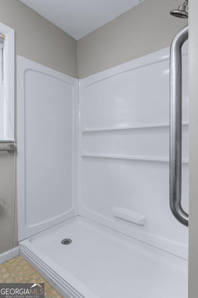 bathroom with a shower stall