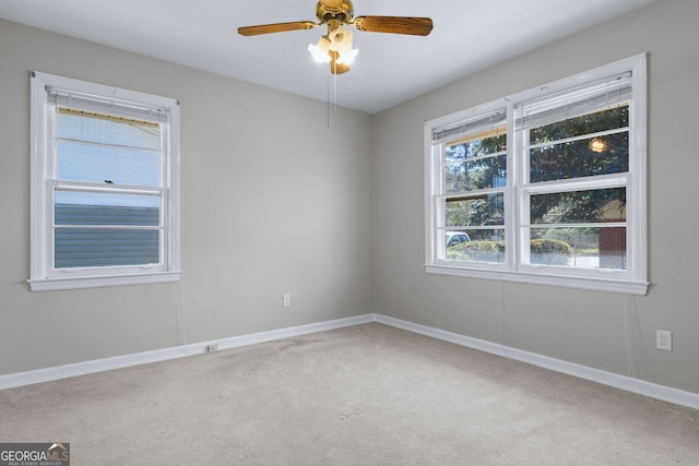 carpeted spare room with baseboards and ceiling fan