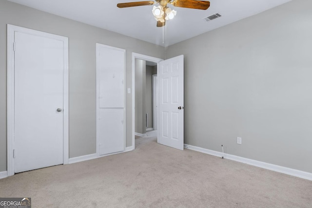 unfurnished bedroom featuring baseboards, visible vents, and carpet floors