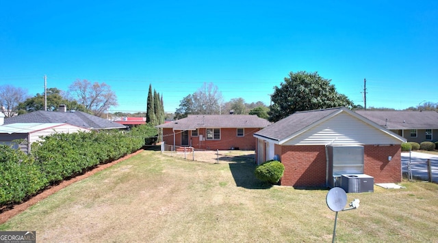 view of yard featuring central AC unit and an outdoor structure