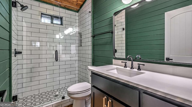 bathroom with vanity, toilet, wood ceiling, and a shower stall