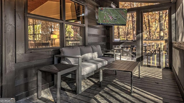 wooden deck with an outdoor living space