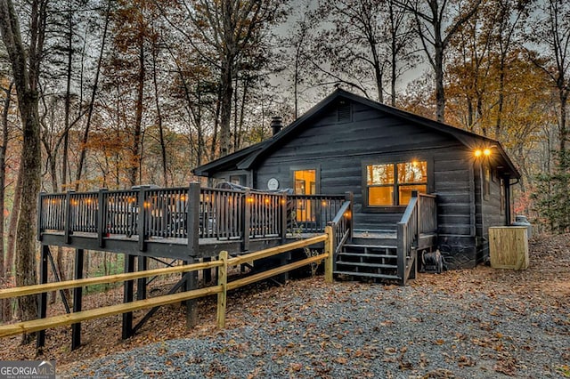 rear view of property featuring a deck