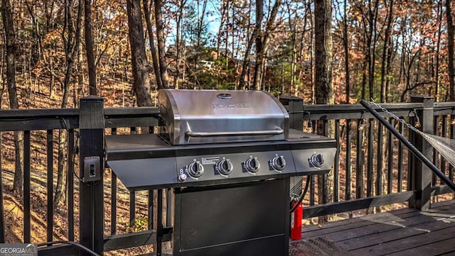 wooden deck featuring area for grilling