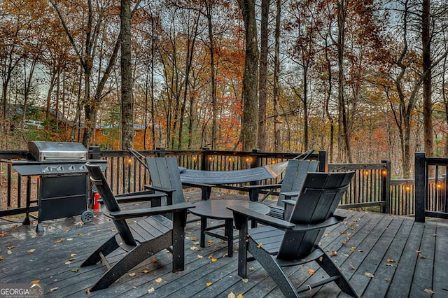 wooden deck featuring a grill
