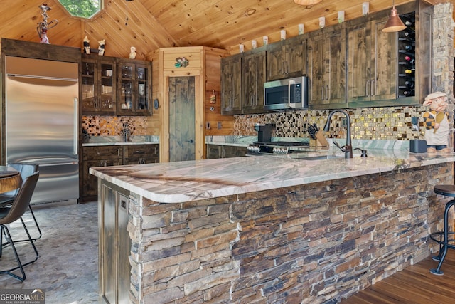 kitchen with a sink, decorative backsplash, glass insert cabinets, wood ceiling, and appliances with stainless steel finishes