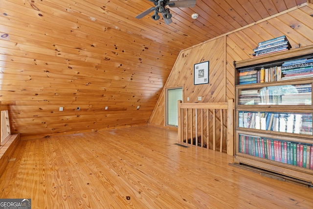 additional living space featuring vaulted ceiling, wooden walls, wood ceiling, and wood finished floors