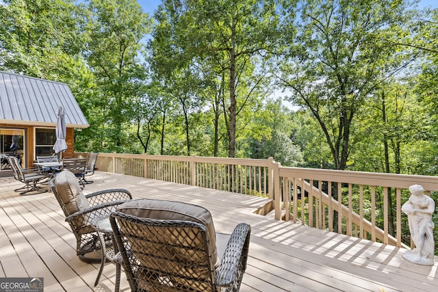 deck with outdoor dining area