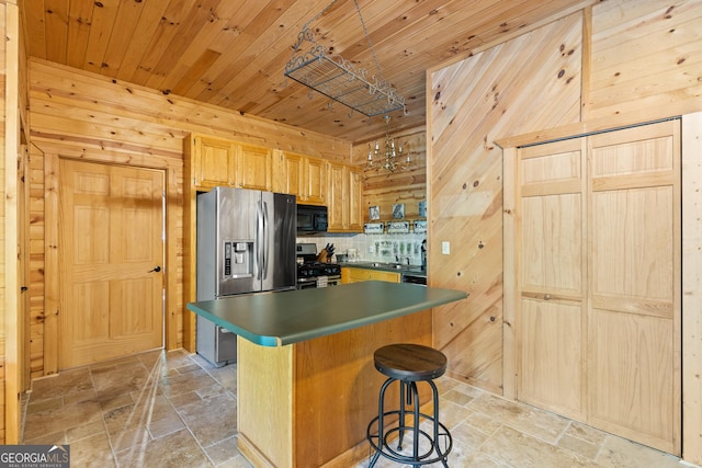 kitchen with wood walls, stone tile floors, decorative backsplash, appliances with stainless steel finishes, and wooden ceiling