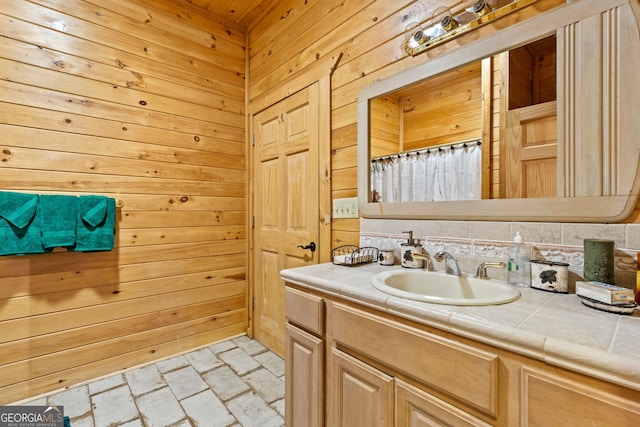 bathroom with wooden walls and vanity