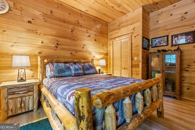 bedroom featuring wood finished floors, wood ceiling, and wood walls