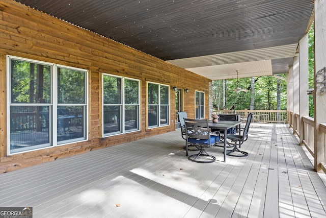 wooden terrace with outdoor dining space