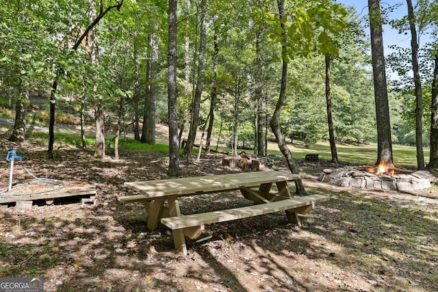 surrounding community featuring a fire pit