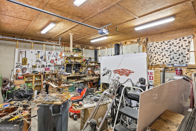 garage with a workshop area and a garage door opener