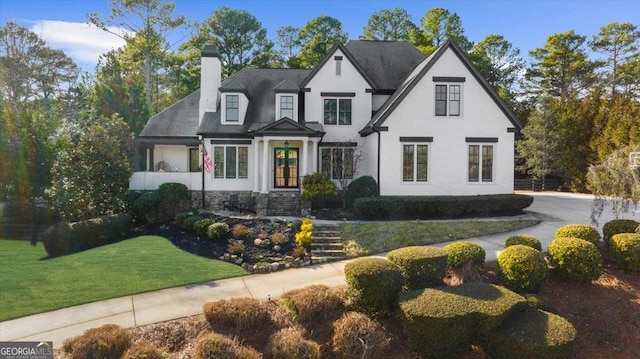 view of front of property with a front yard and a chimney