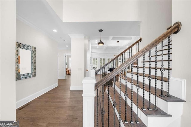 stairway featuring crown molding, baseboards, recessed lighting, wood finished floors, and coffered ceiling