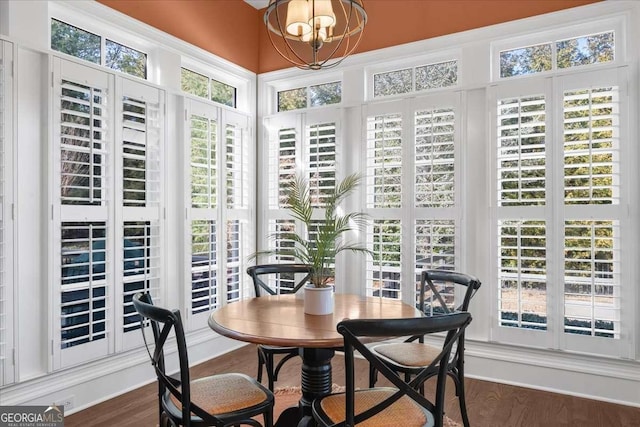 sunroom featuring an inviting chandelier