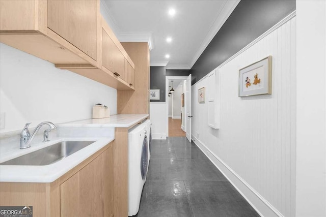 kitchen with crown molding, light brown cabinetry, light countertops, washer / clothes dryer, and a sink