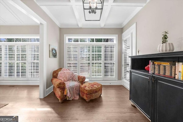 sitting room with beamed ceiling, coffered ceiling, wood finished floors, an inviting chandelier, and baseboards