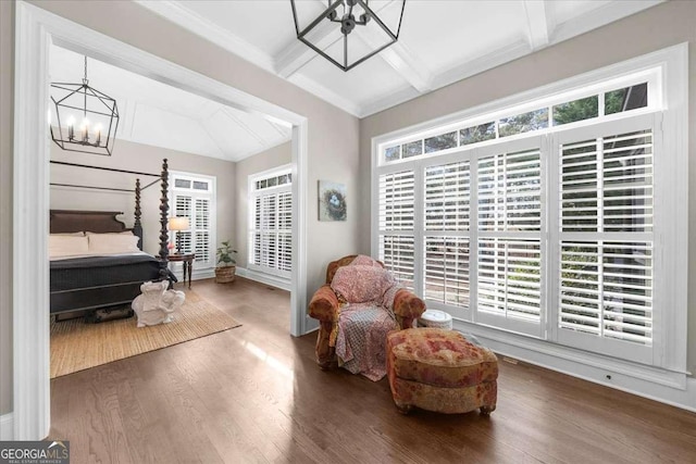 sitting room with beam ceiling, wood finished floors, a wealth of natural light, and a chandelier