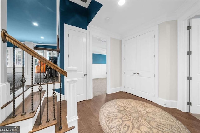 interior space with wood finished floors, stairs, and ornamental molding