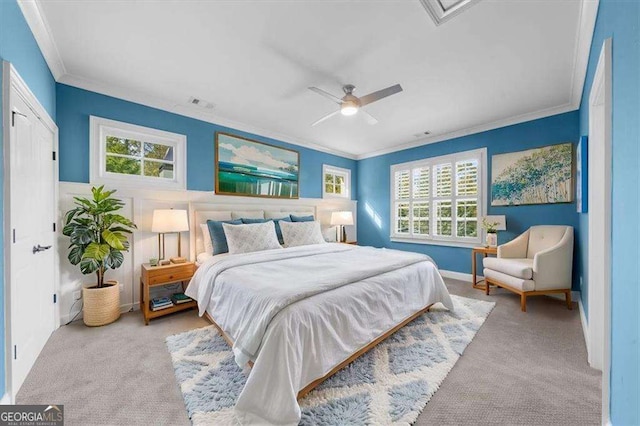 carpeted bedroom featuring visible vents, crown molding, and a ceiling fan