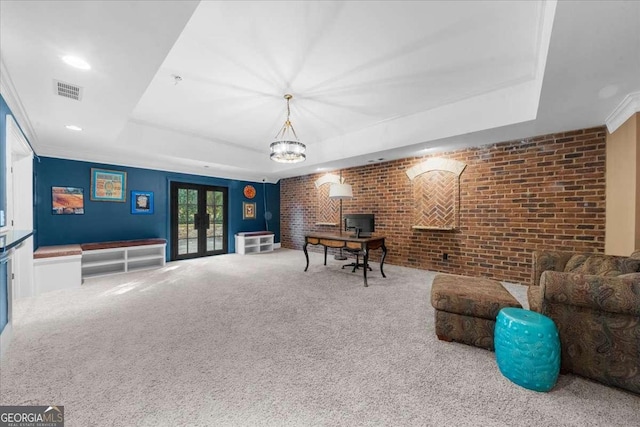 playroom with brick wall, recessed lighting, french doors, a raised ceiling, and carpet flooring