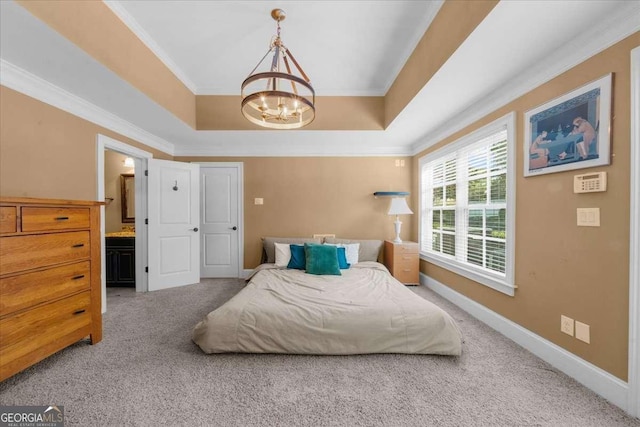 carpeted bedroom with a chandelier, baseboards, a tray ceiling, and ornamental molding