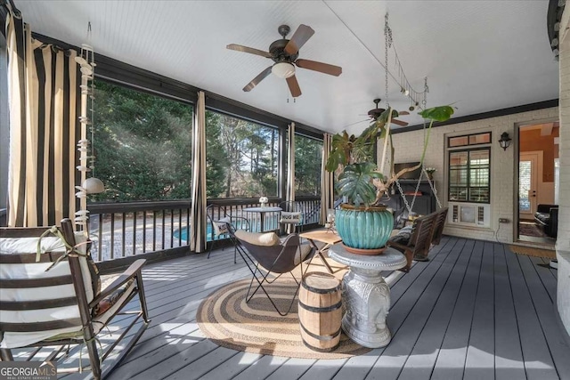 sunroom / solarium with a ceiling fan and a wealth of natural light