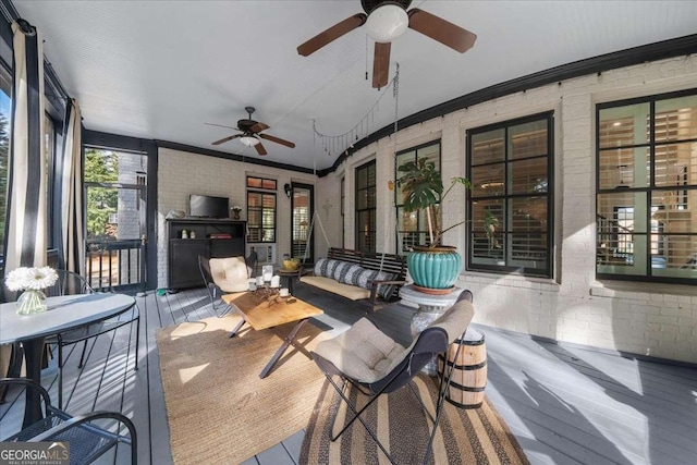 135 Newcastle Ct, Roswell, GA 30076 - sunroom / solarium with a ceiling fan, brick wall, ornamental molding, and an outdoor living space