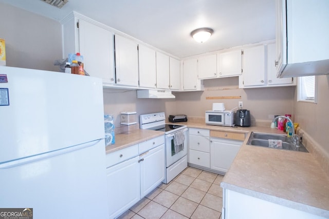 kitchen featuring a sink, under cabinet range hood, white appliances, light countertops, and light tile patterned floors