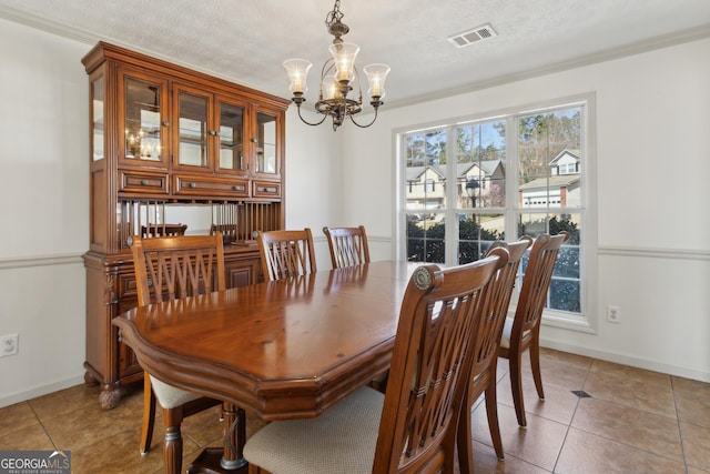 dining area featuring light tile patterned floors, visible vents, a notable chandelier, and a textured ceiling