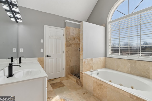 bathroom with a tile shower, a tub with jets, lofted ceiling, and a sink