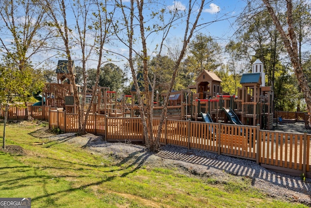 community playground with a lawn and fence