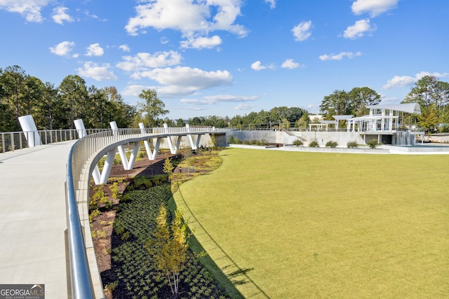 surrounding community with a yard and a water view