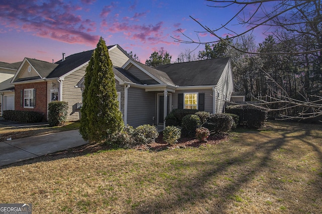 view of property exterior with a lawn and driveway