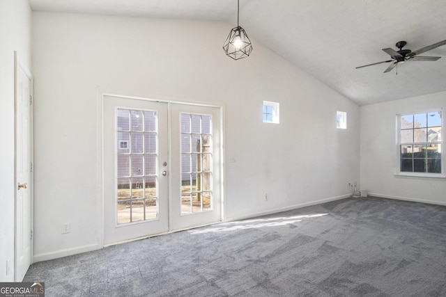 unfurnished room featuring a ceiling fan, vaulted ceiling, carpet flooring, and french doors