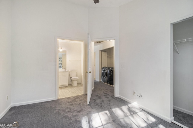 unfurnished bedroom featuring baseboards, carpet, and separate washer and dryer