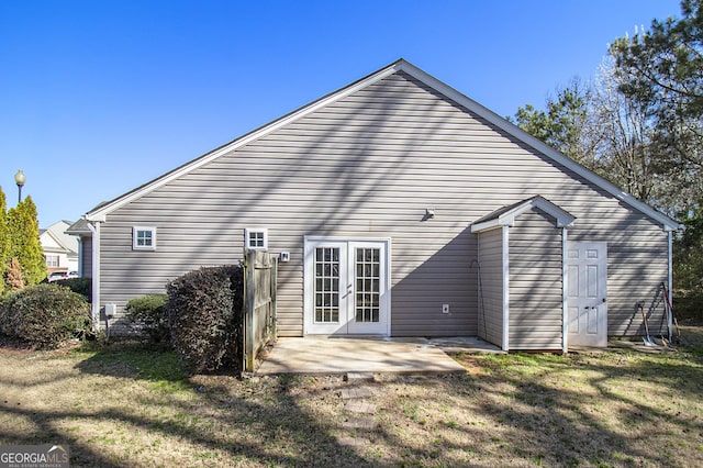 rear view of property with a patio area, a yard, and french doors