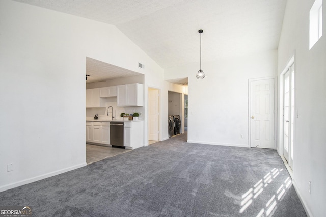 unfurnished living room with visible vents, light carpet, independent washer and dryer, a sink, and baseboards