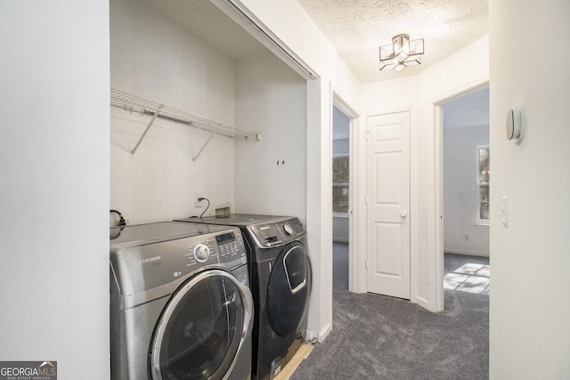 washroom featuring baseboards, carpet, laundry area, a textured ceiling, and separate washer and dryer