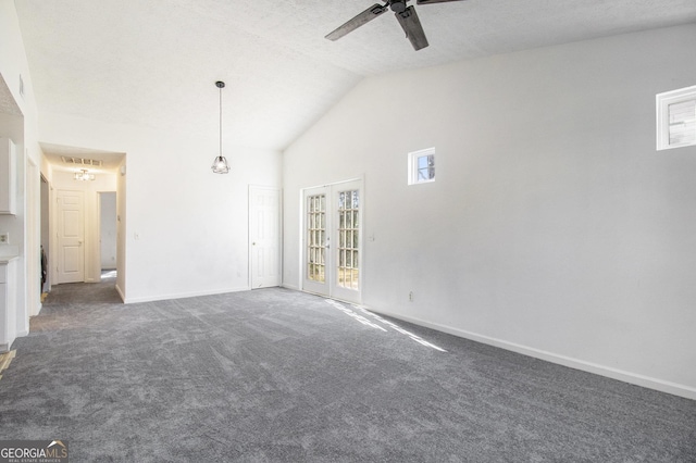 carpeted spare room featuring visible vents, high vaulted ceiling, a ceiling fan, french doors, and baseboards