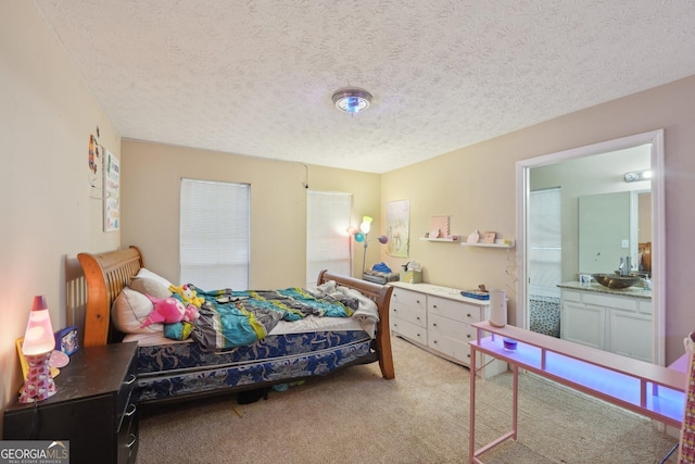 bedroom featuring light colored carpet, a textured ceiling, and a sink