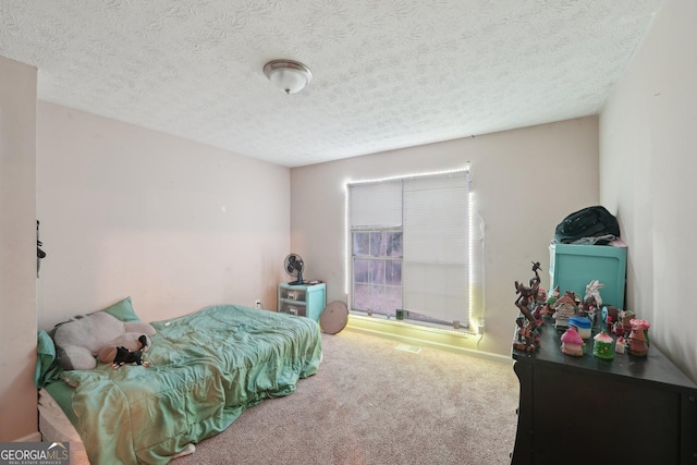 carpeted bedroom featuring a textured ceiling