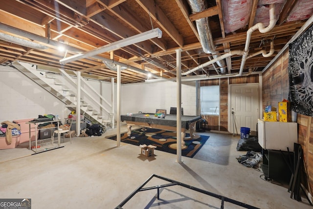 unfinished basement featuring stairs