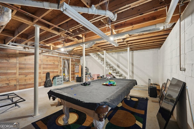 recreation room featuring concrete block wall, unfinished concrete floors, and pool table