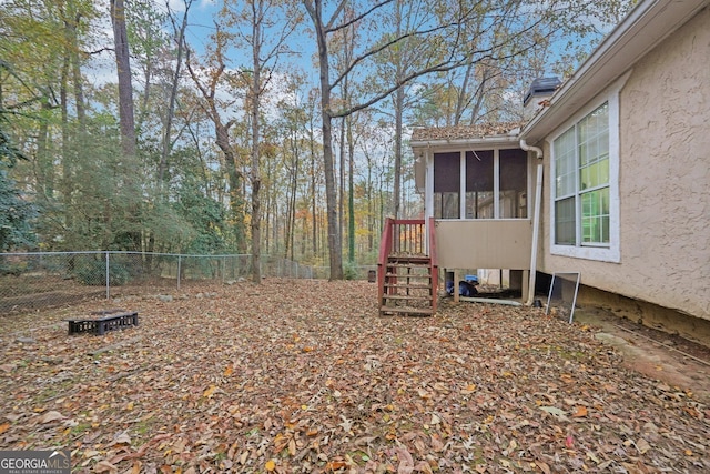 view of yard with a fenced backyard and a sunroom