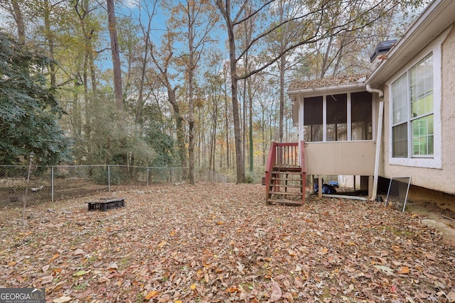 view of yard with fence and a sunroom